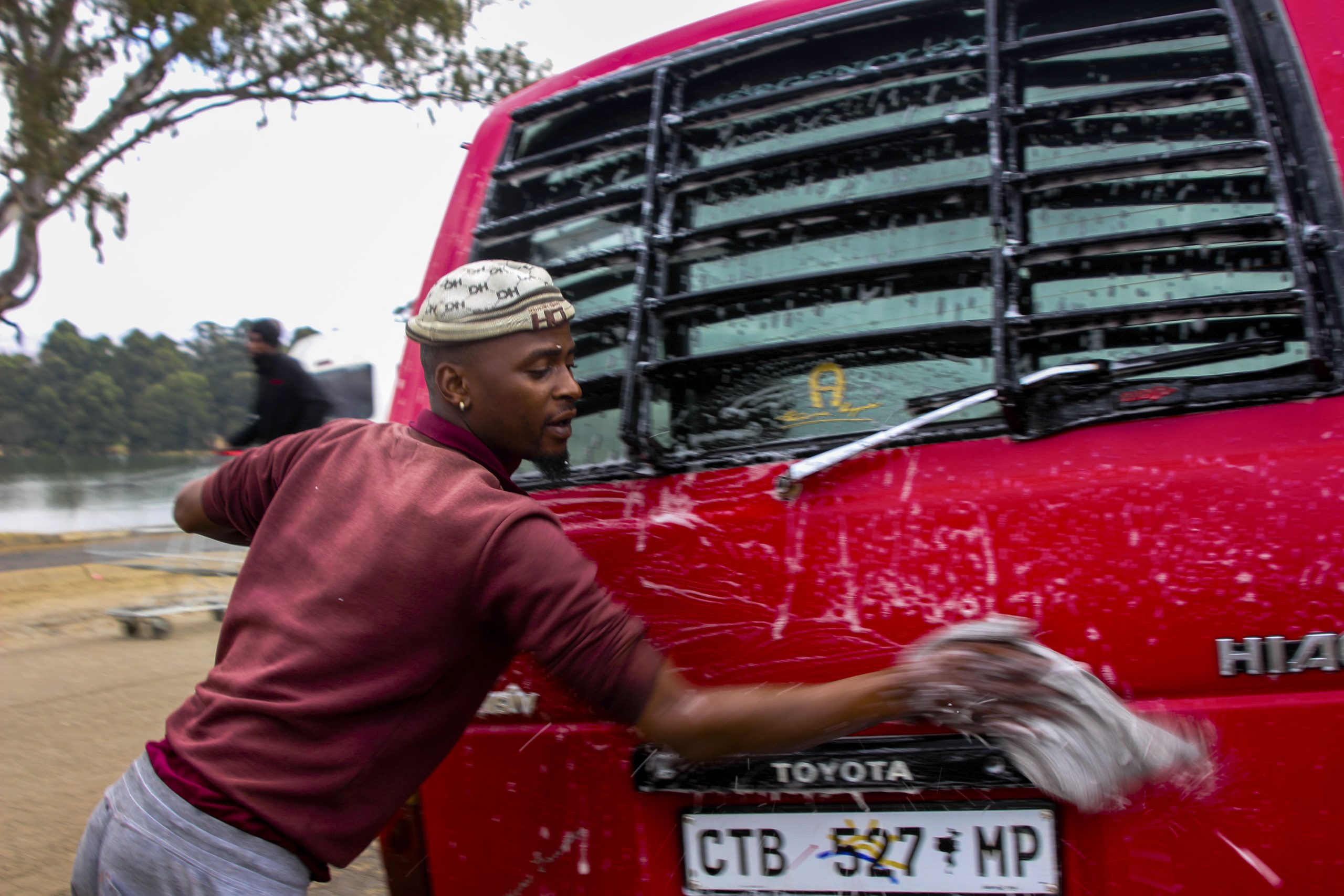 8 June 2020: Sibusiso Motha, 26, survives by washing taxis at Mkhondo taxi rank. If the drivers don’t make enough money through trips, his job is directly affected as it relies on the taxi operators’ cash flow. (Photograph by Magnificent Mndebele)