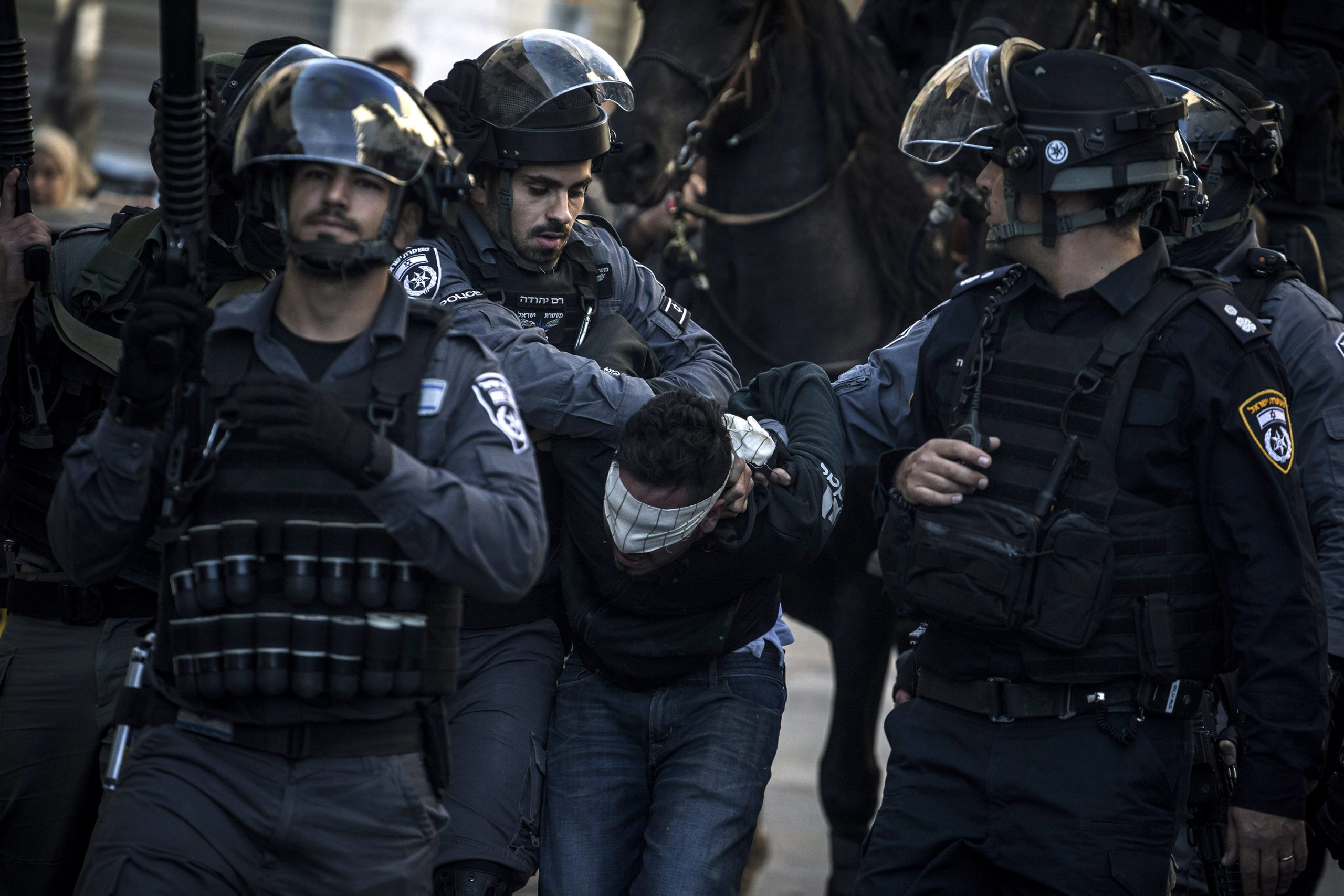 9 December 2017: Police officers arrest a Palestinian protester in Jerusalem. The Israeli police have long been used to crush Palestinian resistance and enforce the occupation of Palestine. (Photograph by Ilia Yefimovich/ Getty Images)