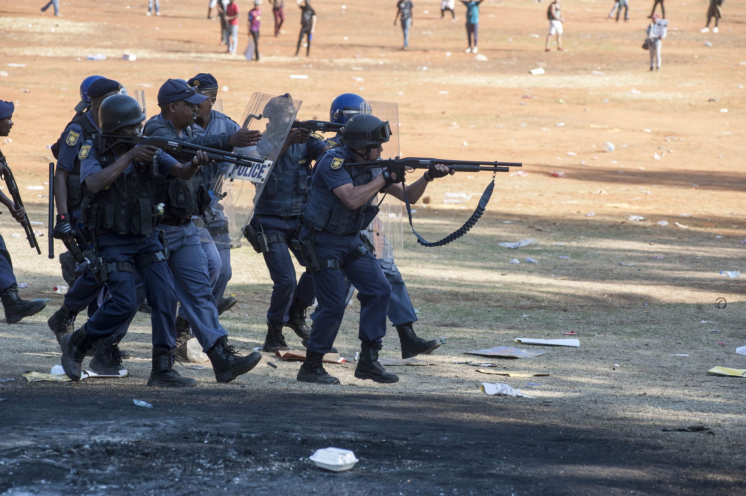 23 October 2015: South African police officers move in a military formation as they open fire on students who were protesting against fee increases at the Union Buildings in Pretoria. (Photograph by Ihsaan Haffejee)