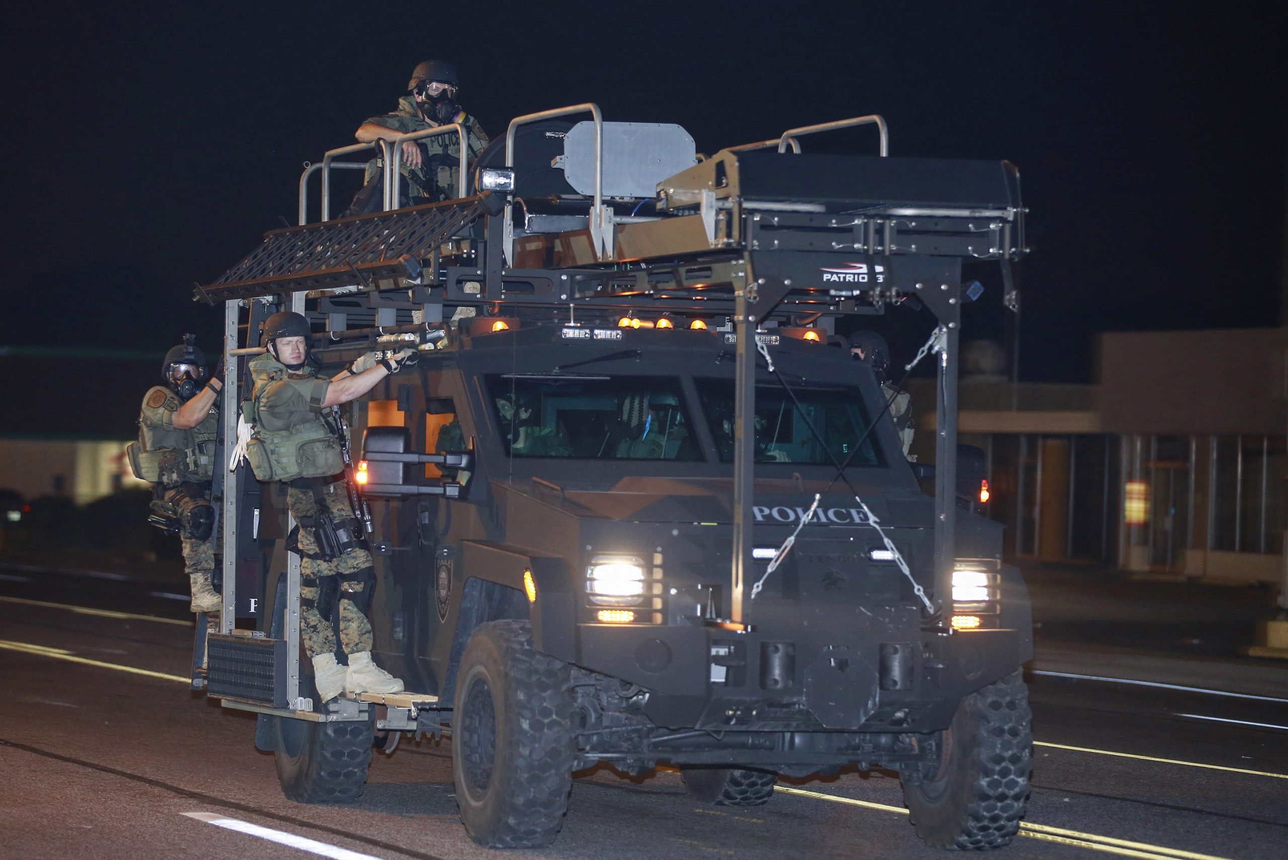 18 August 2014: Officers on a militarised police vehicle in Ferguson, Missouri, as protests continued over the death of 18-year-old Michael Brown. (Photograph by Bilgin Sasmaz/ Anadolu Agency/ Getty Images)