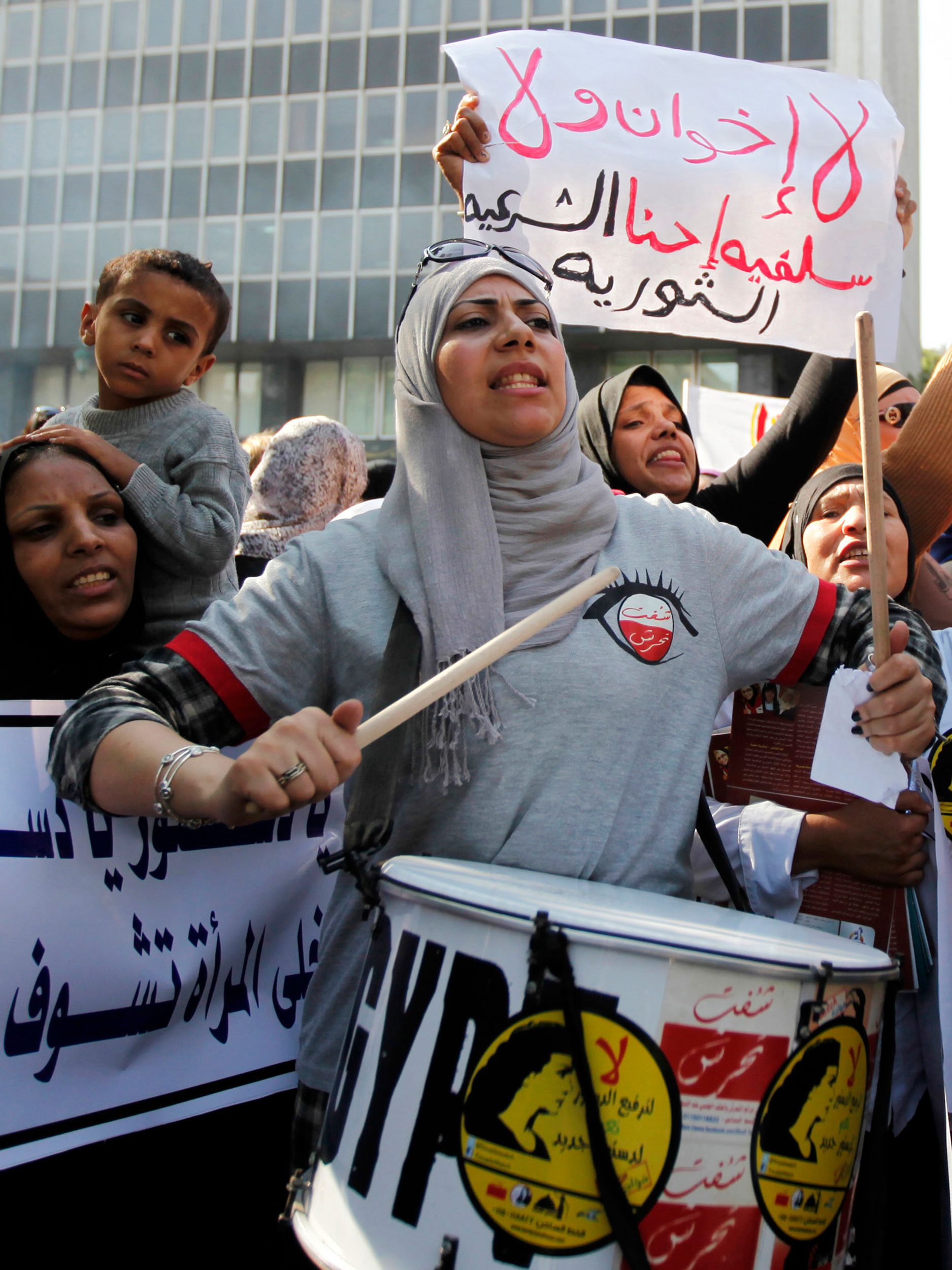 13 November 2013: Protesters demand more rights for women in front of the Shura Council, or upper house of parliament, in Cairo. (Photograph by Reuters/ Mohamed Abd El-Ghany)