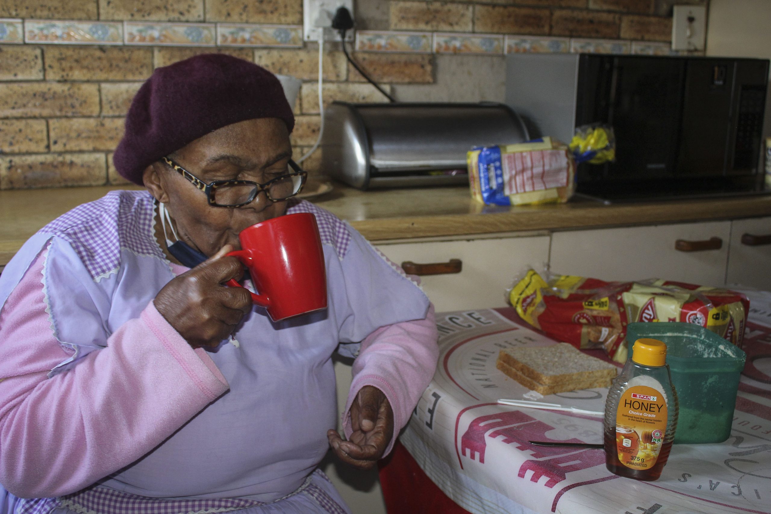 28 July 2020: Winnie Ndlovu, 76, drinks hot water with honey, garlic and ginger to relieve her chest and throat. (Photograph by Tony Carnie)