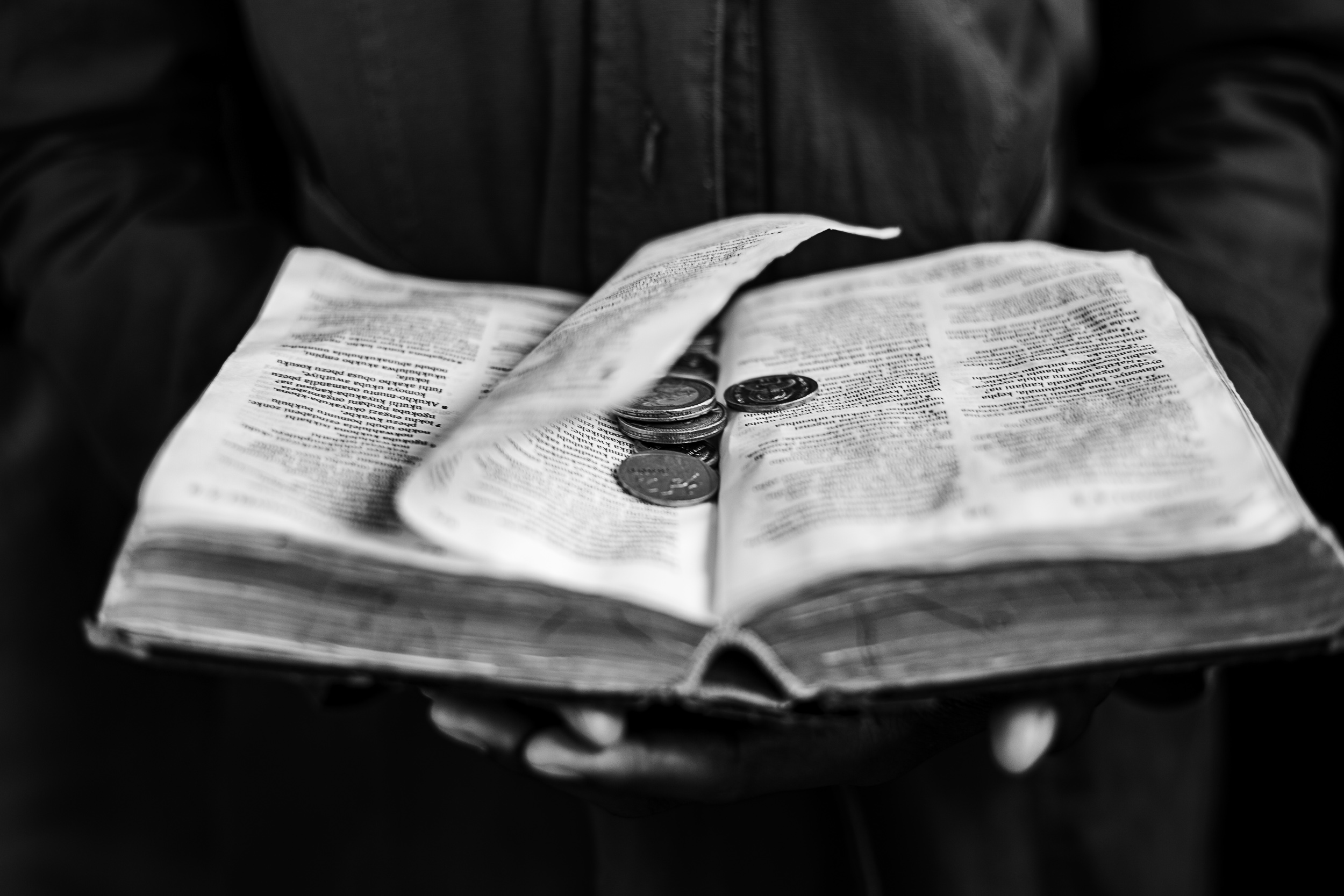 Undated: Okweshumi – Coins are placed on a Bible as tithes at the Ukuphila KwamaKrestu church.
