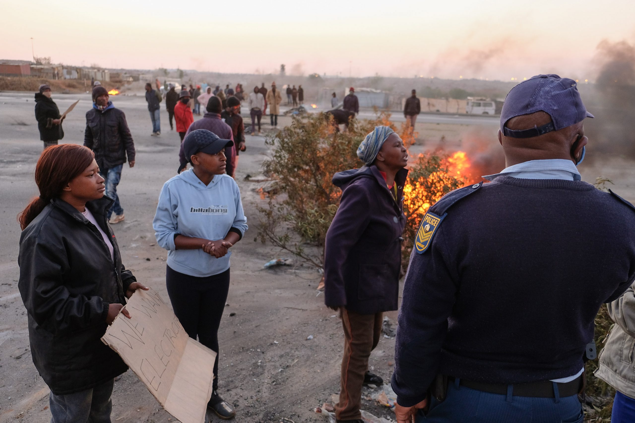 25 August 2020: Residents of the Doornkop shack settlement Tamara Bhengu* and Kelebogile and Constance Pogiso engage with the police before being fired at with rubber bullets and tear gas. 